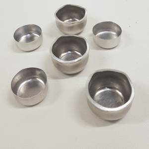 6 deep drawn aluminium cups with varied thickness and different earing profiles