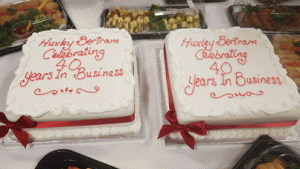 2 celebration cakes celebrating 40 years of Huxley Bertram being in business